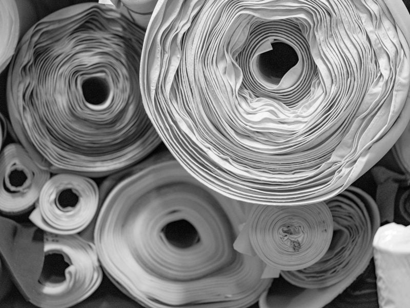 Rolls of upholstery and technical fabrics in the warehouse